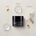 Vie Collection Mela Bright Dark Spot Brightening Cream 50ml flatlay on limestone surface with Vitamin C, Niacinamide, Sea Lily Extract, Hyaluronic Acid, and Vitamin E