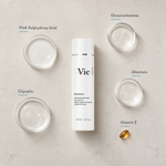 Vie Collection Mésoforce Gentle Micro-Exfoliating Lotion with PHA 125ml flatlay on limestone surface with PHA Polyhydroxy Acid, Gluconolactone, Glycerin, Allantoin, and Vitamin E