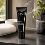 Vie Collection Retinopur Intensive Retinol Mask 50ml premium matte-black tube styled on a dark marble vanity with white towels and greenery for Beauty Collective consumer retail.