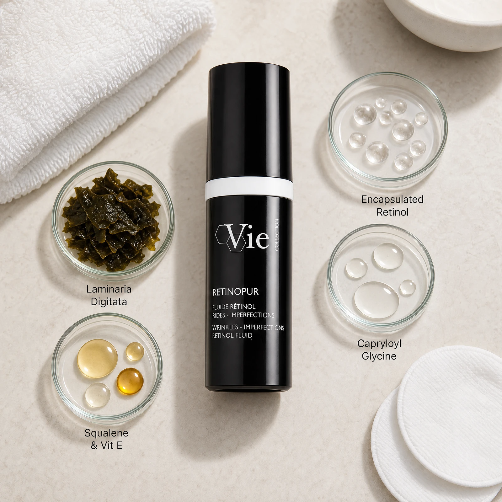 Vie Collection Retinopur Wrinkles Imperfections Retinol Fluid 30ml ingredient flatlay with encapsulated retinol, capryloyl glycine, laminaria digitata, and squalene with vitamin E in clean glass petri dishes.
