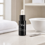 Vie Collection Vita B3 Concentrated Solution 15ml professional matte-black dropper bottle styled in a serene clinical spa treatment room for Beauty Collective Pro.