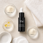 Vie Collection Vita E Ferulic Concentrated Solution 15ml ingredient flatlay with ferulic acid, vitamin C, and vitamin E in clean glass petri dishes.